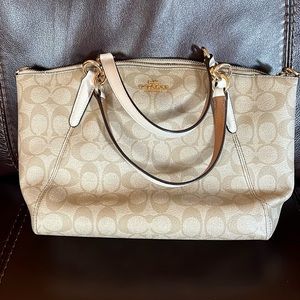 Beige and white Coach purse.